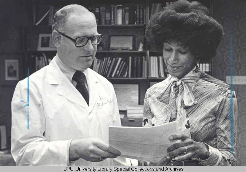 Alicia Monroe, a medical student, accepts the McClean Award from Steven Beering in 1976