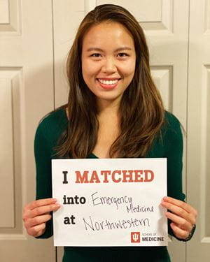 evelyn huang holds a sign with her match on match day