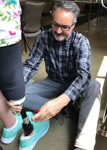 Jeffrey Denune fitting a patient with a prosthetic leg