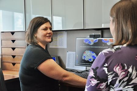 Dr. Hulvershorn shows brain scan images to a student