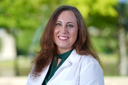 Katherine Hiller, MD, in white coat