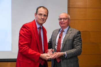 Michael Moore, MD, with Dean Jay Hess and thee Faculty Mentoring Award