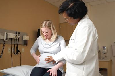 Dr. Brownsyne Tucker-Edmonds with a pregnant patient
