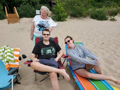 Devin on the beach with his grandma and girlfriend