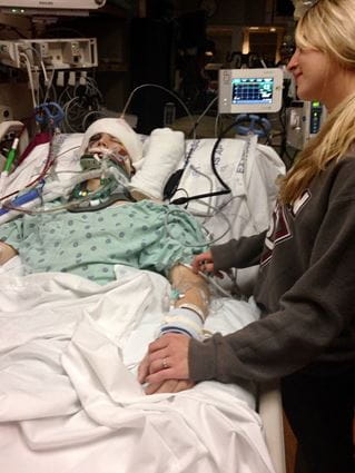 Cameron in a coma in the hospital with Chelsea by his side holding his hand