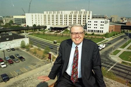 Walter Daly sits on a rooftop atrium overlooking the IUPUI campus in 1995