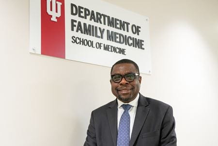 Kola Okuyemi stands in front of the Department of Family Medicine sign