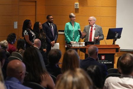 Dean Jay Hess and other IU School of Medicine leaders at front of room with crowd, answering questions at Spring 2024 All School Meeting.