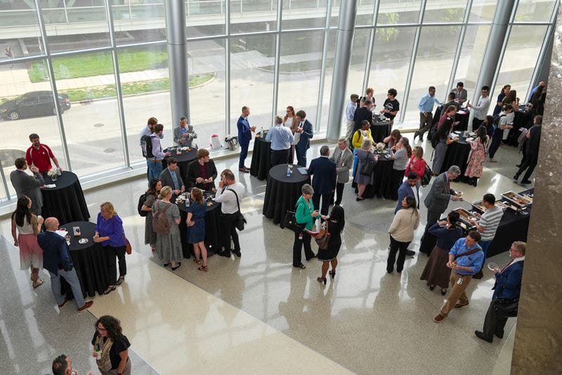 View from above of guests mingling at the reception following the Spring 2024 All School Meeting