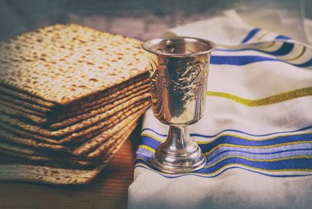 matzah and a silver wine glass representing the jewish holiday of passover