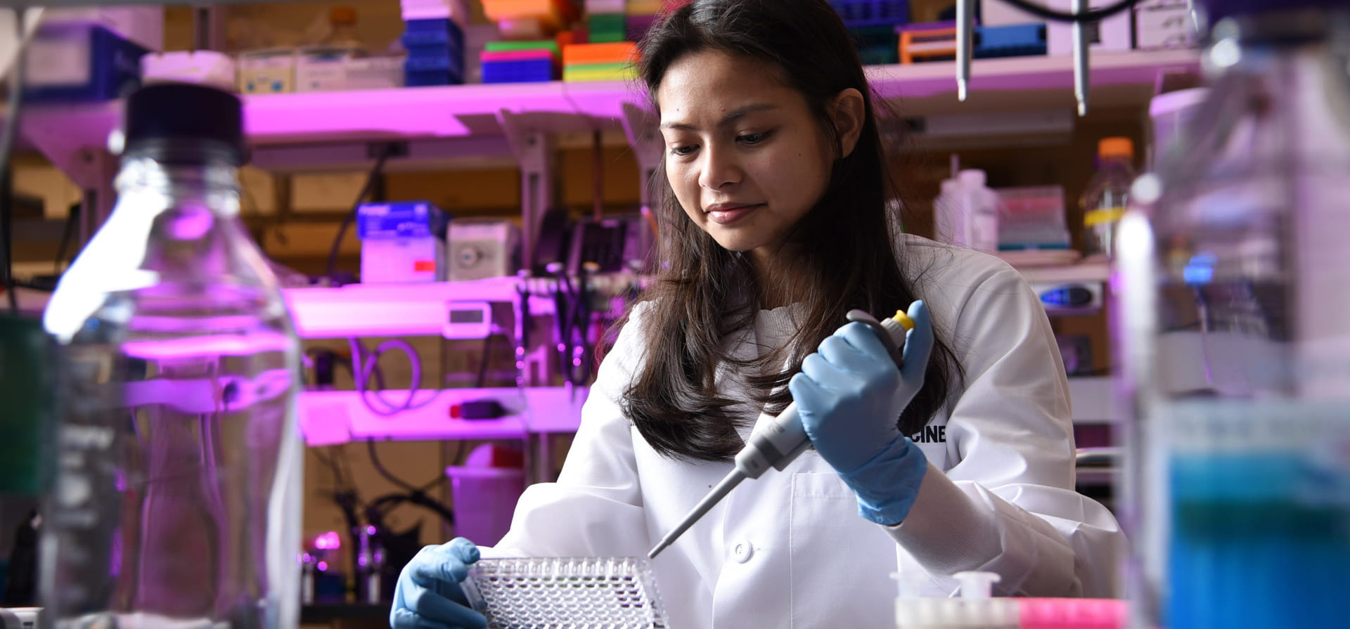PhD student works in the lab preparing samples