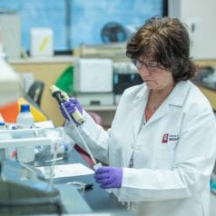 Dr. Joan Cook-Mills working with a pipette in her lab