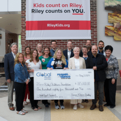 Representatives from Reason to Dance, Riley Children's Foundation, Riley Children's and the Wells Center pose with a large check