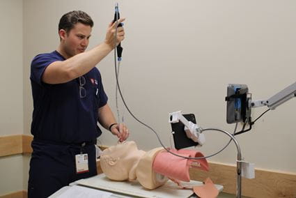 Individual working with a scope in a simulation lab