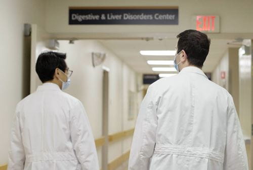 Two physicians walk down the hall toward the digestive and liver disorders center in the hospital