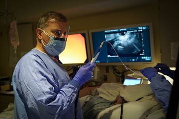 Photo of Dr. Al-Haddad performing a procedure in the endoscopy lab.