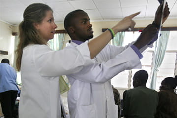 two residents examine a chart together during the kenya elective