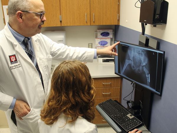 Dr. Robert Bielski and a resident reviews an x-ray in an exam room at Riley Hospital.