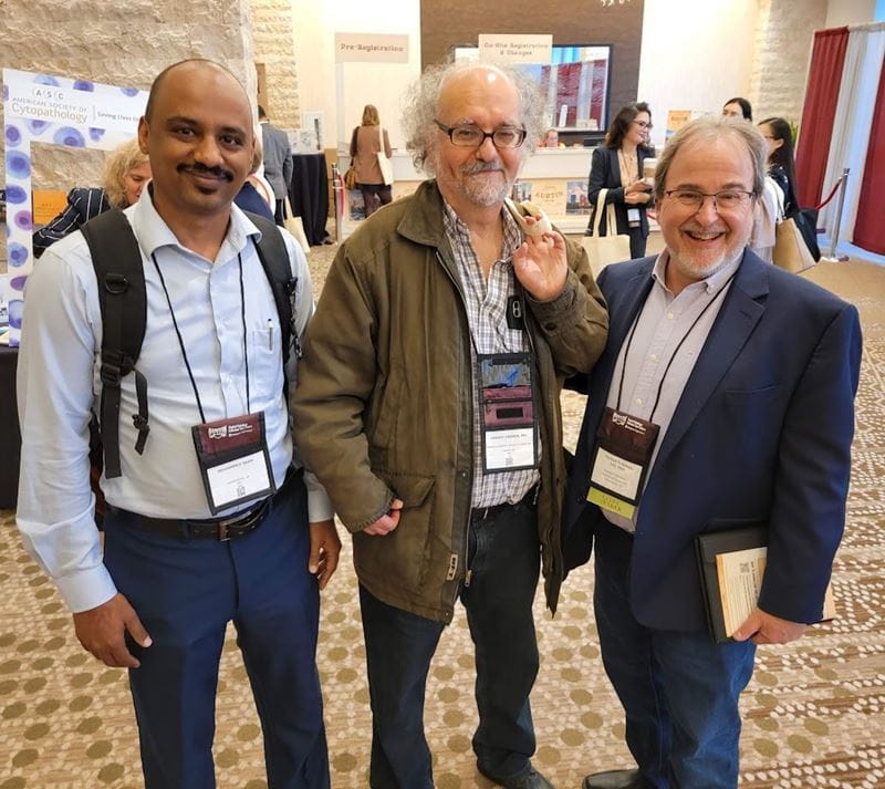 three department members at a conference