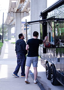 Two people ordering from food truck