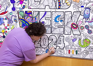 Person coloring in a poster