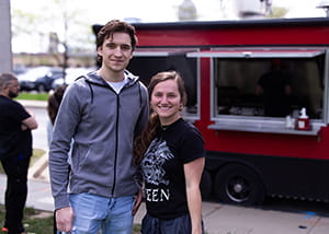 Two people in front a food truck