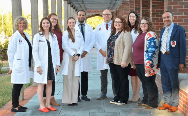group photo of Surgical Skills Lab Team in white coats