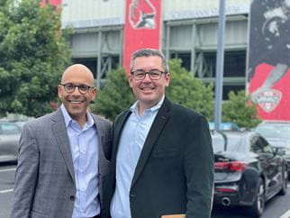 Left to right: Karl Y. Bilimoria, MD and Anthony L. Shanks, MD, MS, stand outside a stadium.