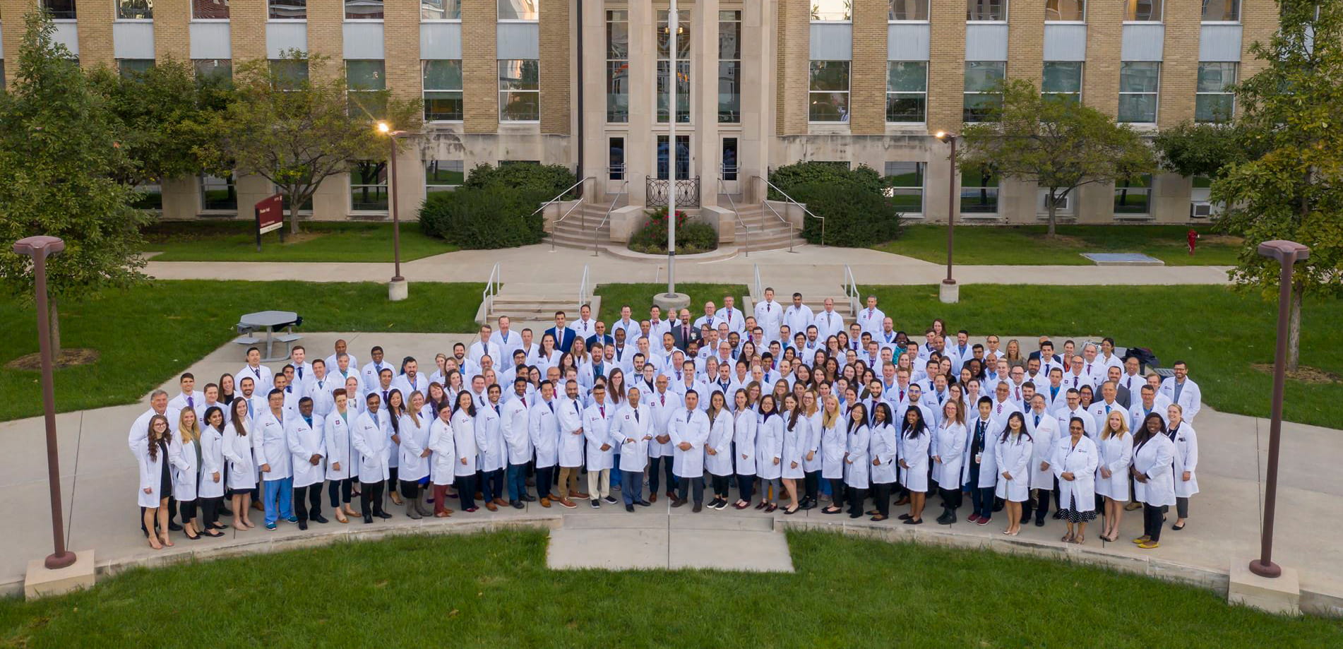 Group photo of all Surgical faculty, residents and fellows in front of IU Medicine School.