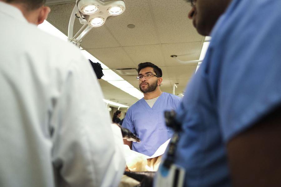 Medical student Dhruv Solanki listens to an instructor in the anatomy lab at IU School of Medicine.
