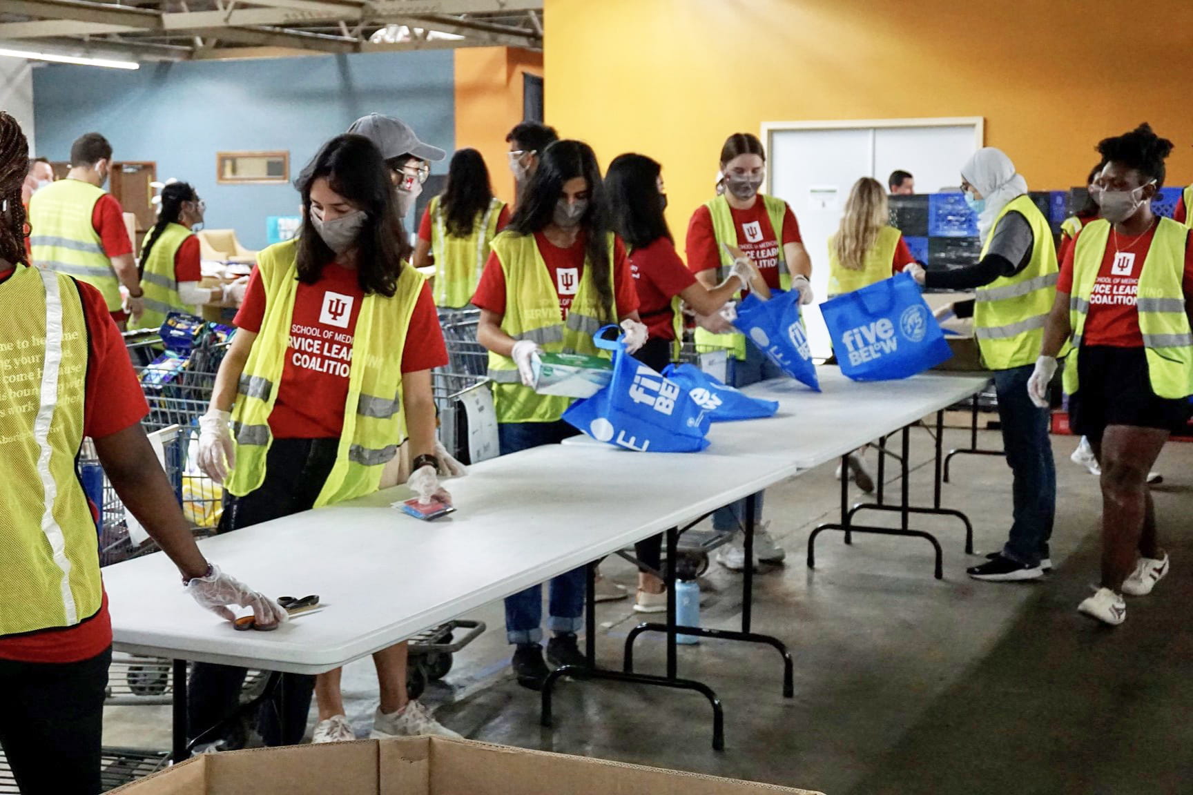 students pack food bags during a service day at the foodbank of northwest indiana