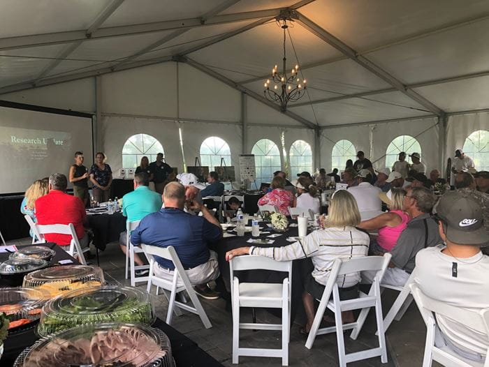 Jamie Renbarger, MD, and Karen Pollok, PhD, sharing research updates with people at the inaugural Tyler Trent golf outing